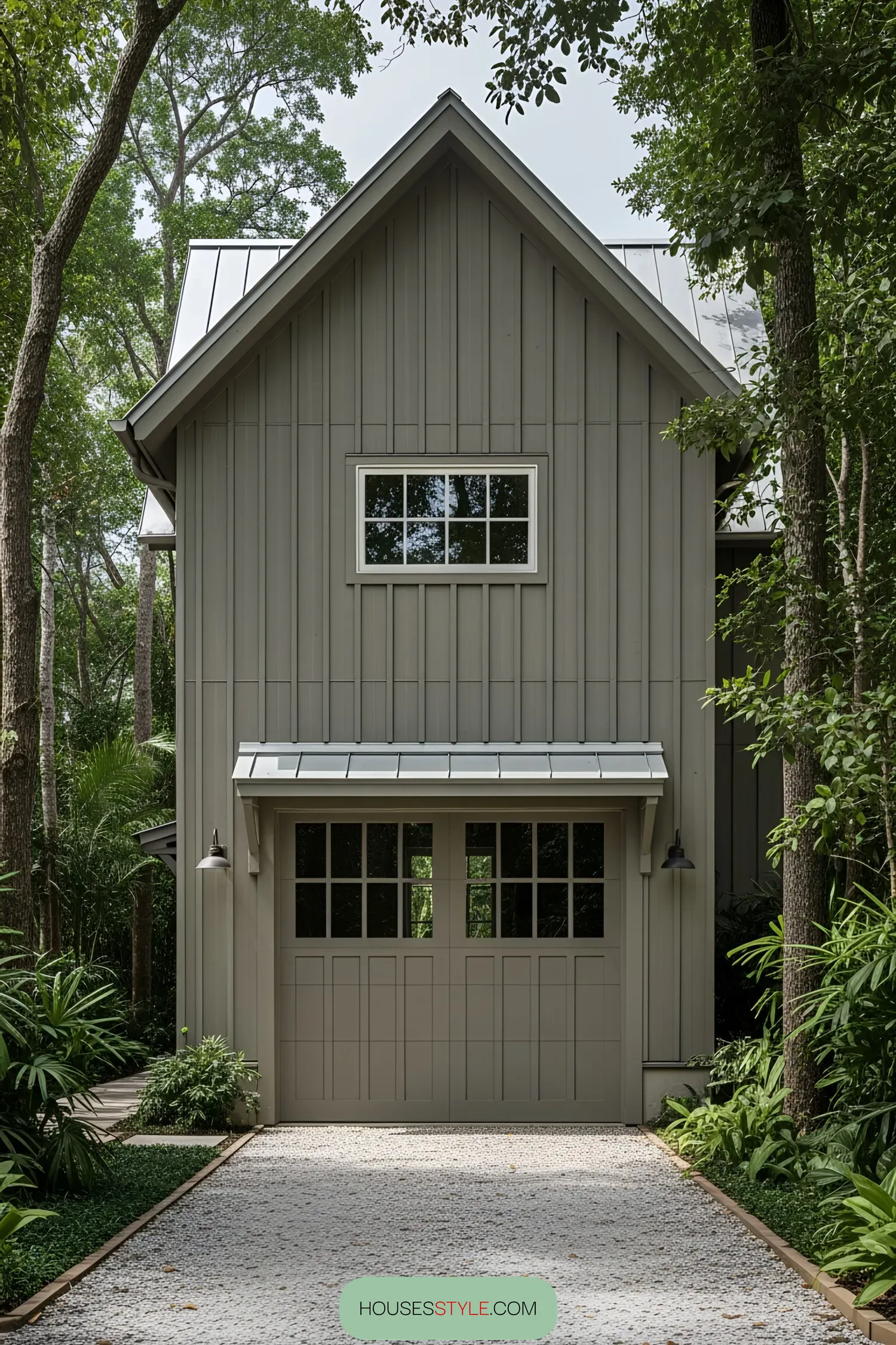 Modern farmhouse with a garage surrounded by greenery