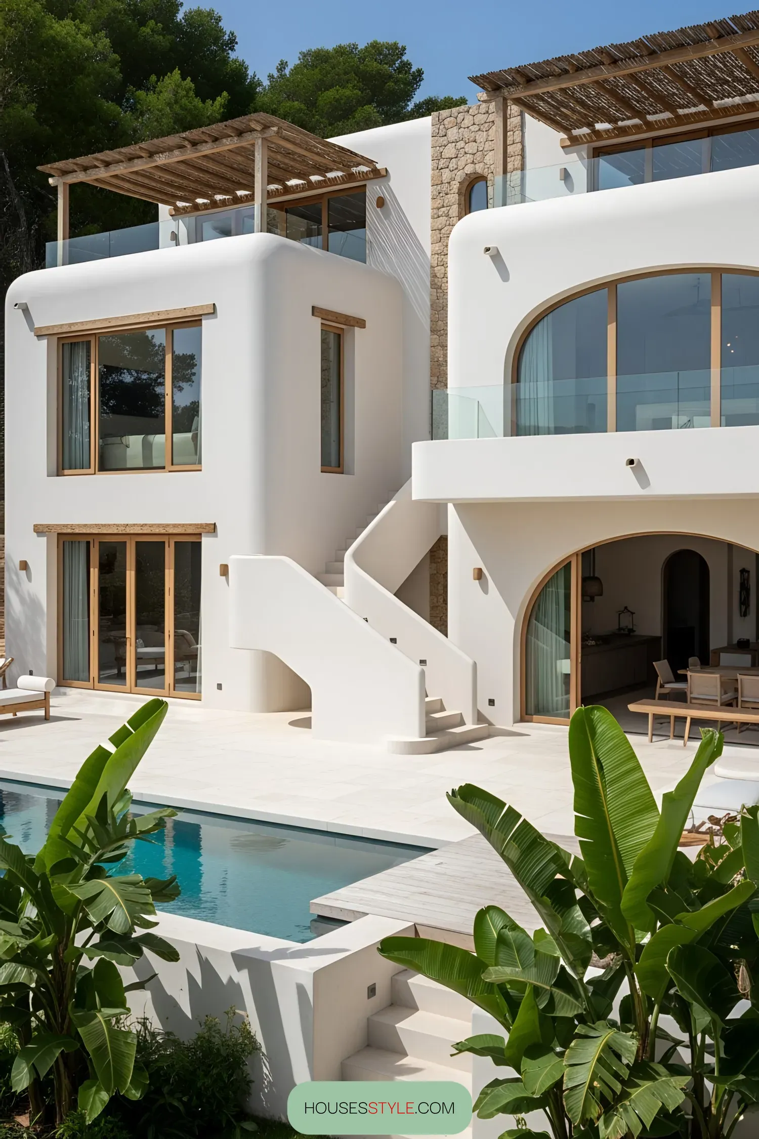 Modern coastal house with a pool surrounded by lush greenery