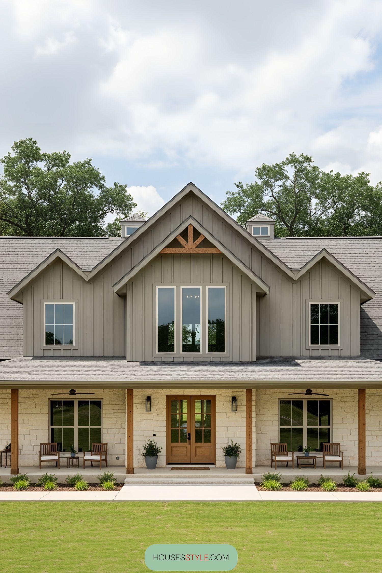 A beautifully inviting barn-style home with a spacious wraparound porch